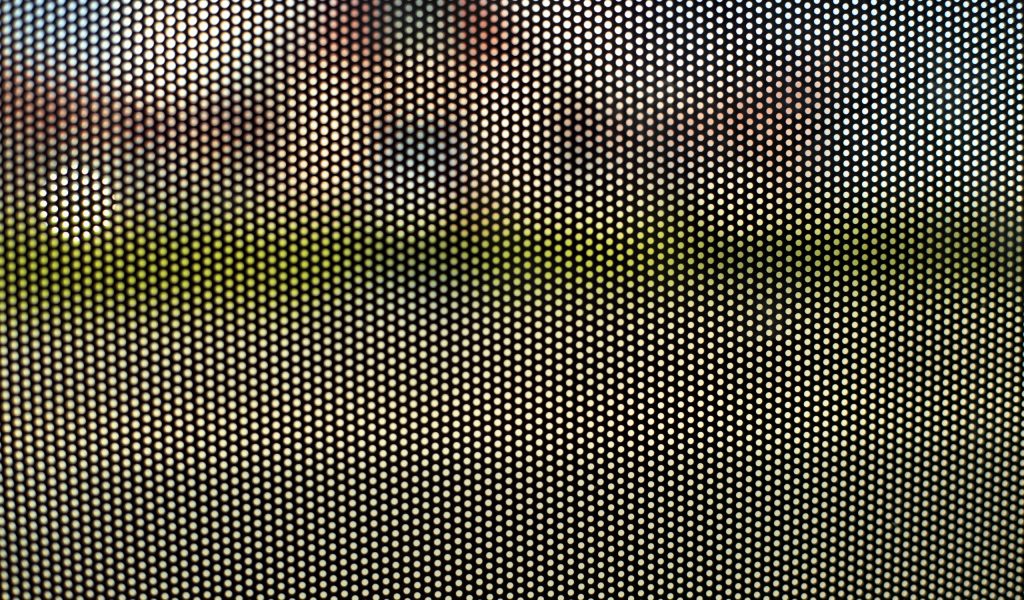 Mesh texture on glass. Shooting window. Small cage. Textured surface.